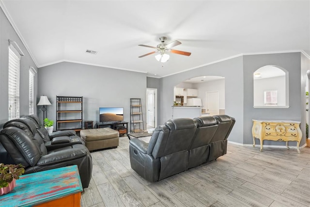 living room with ceiling fan, ornamental molding, vaulted ceiling, and light hardwood / wood-style flooring