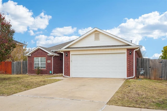 ranch-style house with a garage and a front yard