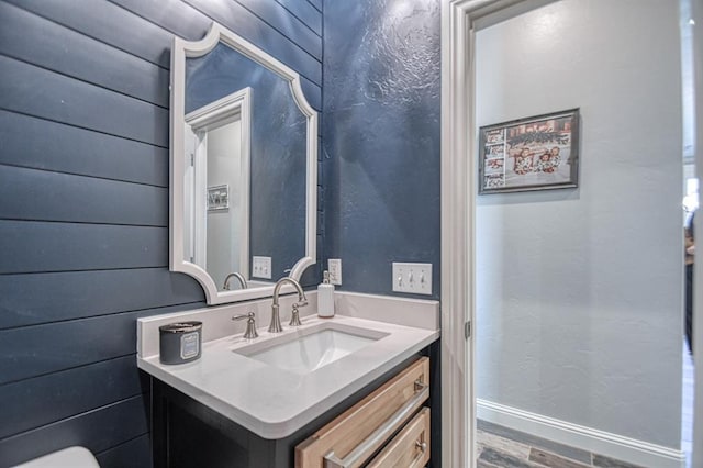 bathroom with hardwood / wood-style floors and vanity