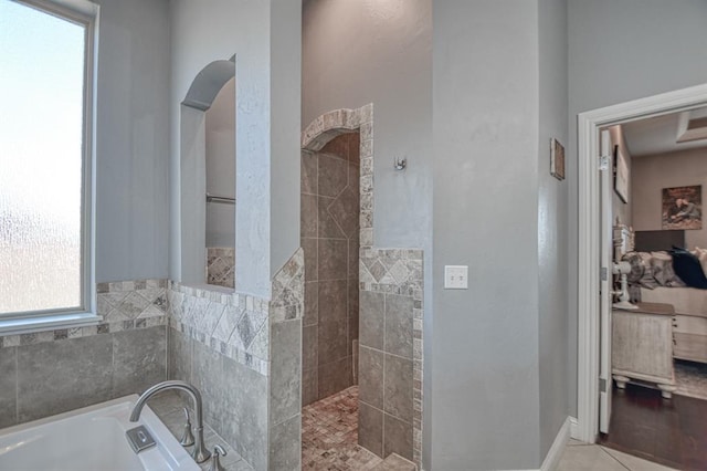 bathroom featuring tile patterned flooring and shower with separate bathtub