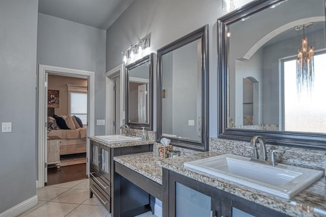 bathroom featuring tile patterned flooring, vanity, and an inviting chandelier