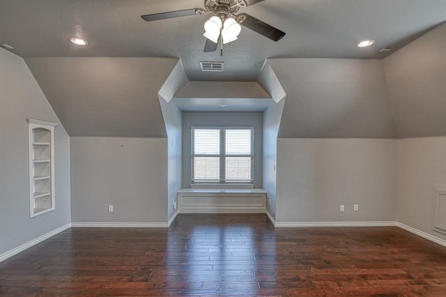 bonus room with vaulted ceiling, built in shelves, ceiling fan, and dark hardwood / wood-style floors