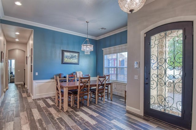 dining space with a chandelier, dark hardwood / wood-style floors, and ornamental molding