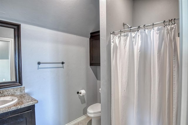 bathroom featuring vanity, a shower with shower curtain, and toilet