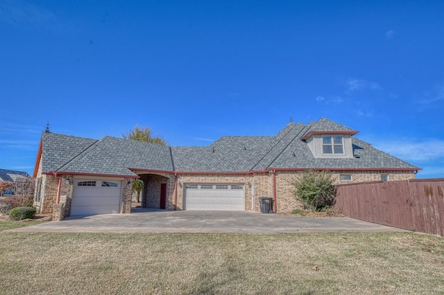 view of front facade with a front lawn and a garage