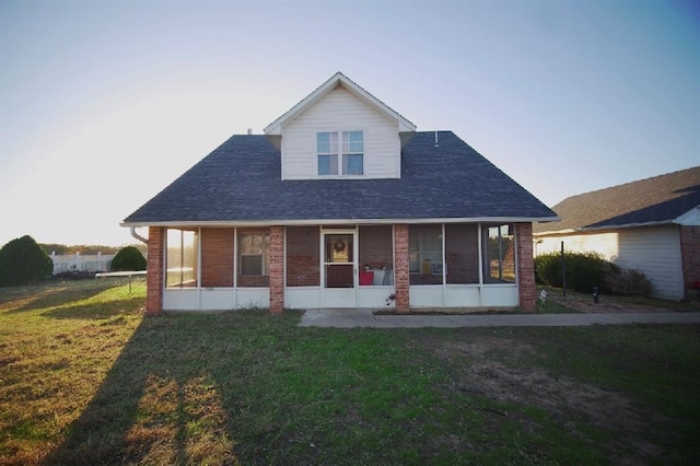 rear view of house featuring a lawn