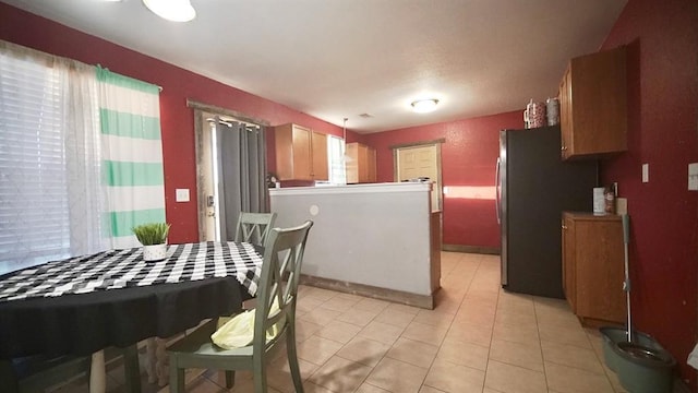 kitchen featuring stainless steel fridge and light tile patterned flooring