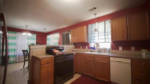 kitchen featuring black range with electric stovetop, kitchen peninsula, white dishwasher, and hanging light fixtures