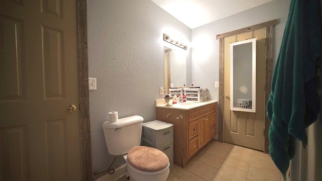 bathroom featuring tile patterned floors, vanity, and toilet