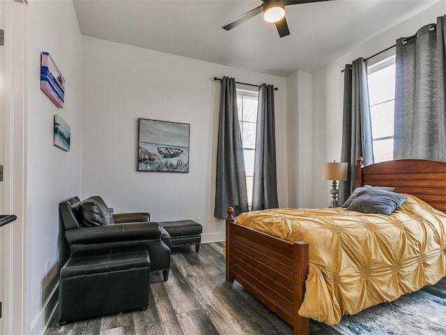 bedroom with multiple windows, ceiling fan, and dark wood-type flooring