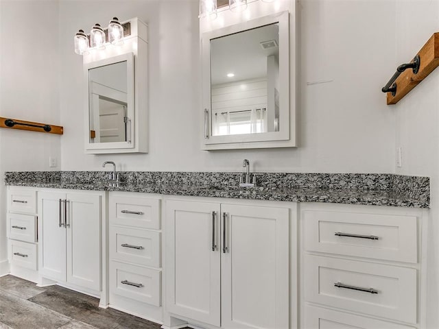 bathroom with hardwood / wood-style floors and vanity