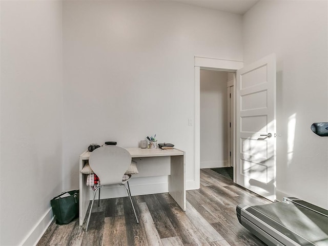 home office with dark hardwood / wood-style floors