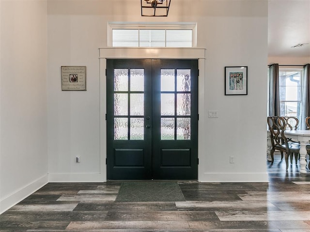 entrance foyer with french doors, dark hardwood / wood-style floors, and plenty of natural light