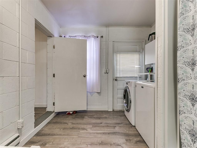 washroom with separate washer and dryer, crown molding, light hardwood / wood-style flooring, and a baseboard heating unit