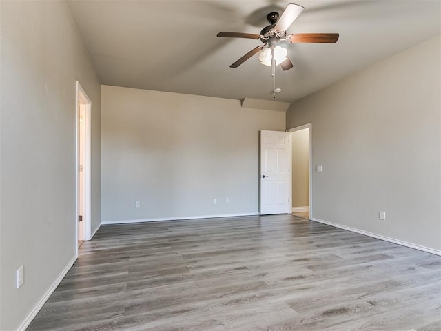 unfurnished room with ceiling fan and hardwood / wood-style flooring