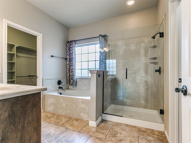 bathroom with separate shower and tub and tile patterned floors