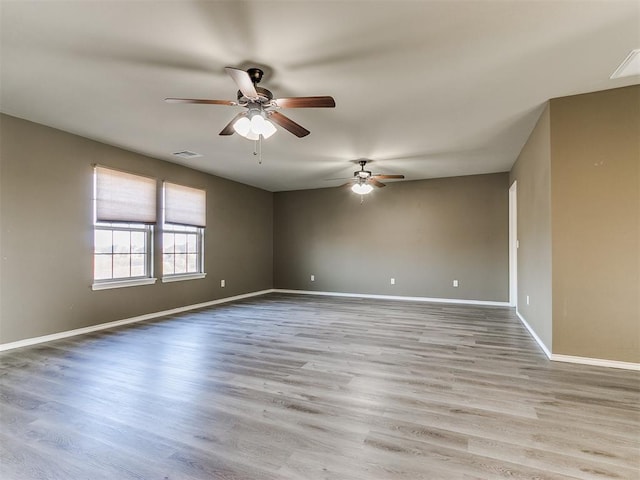 empty room with light hardwood / wood-style floors and ceiling fan