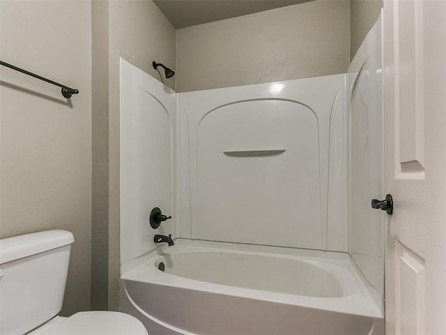 bathroom featuring shower / bathing tub combination and toilet