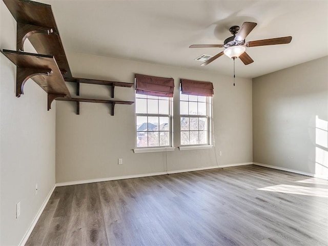 empty room featuring hardwood / wood-style floors and ceiling fan