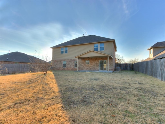 back of property featuring a lawn