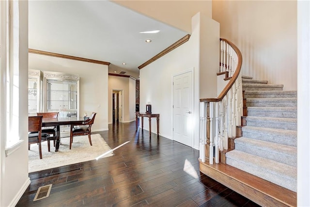 foyer entrance featuring dark hardwood / wood-style floors and ornamental molding