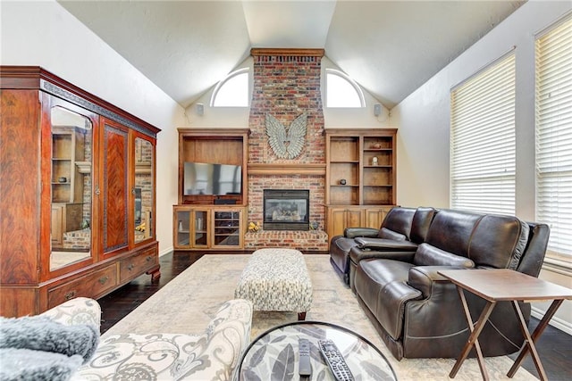 living room with a brick fireplace, high vaulted ceiling, and light wood-type flooring