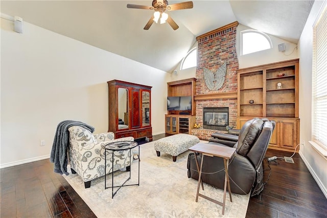 living room with a fireplace, dark hardwood / wood-style flooring, high vaulted ceiling, and ceiling fan