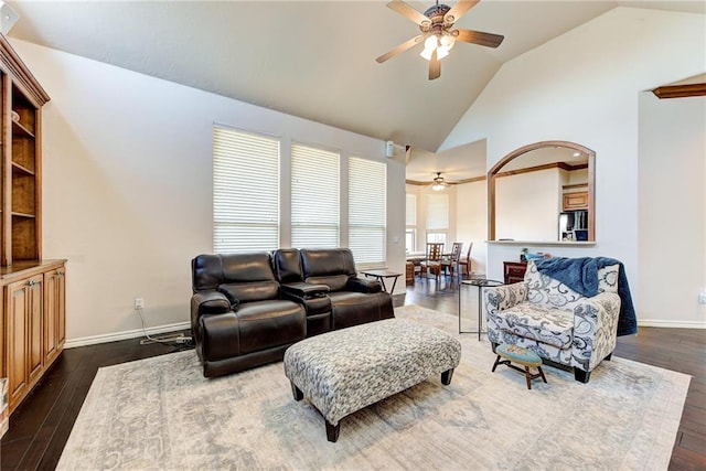 living room with ceiling fan, dark wood-type flooring, and vaulted ceiling