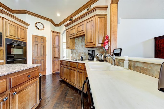 kitchen with sink, tasteful backsplash, dark hardwood / wood-style flooring, black appliances, and ornamental molding