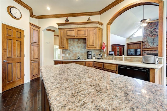 kitchen with ceiling fan, light stone counters, dark hardwood / wood-style floors, crown molding, and black appliances