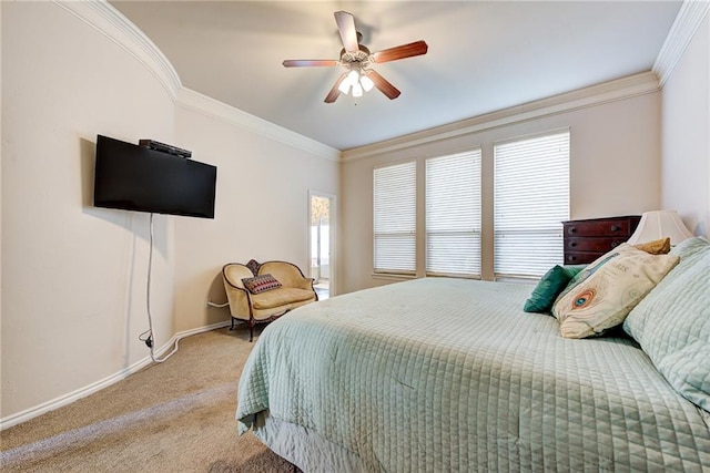 carpeted bedroom featuring ceiling fan and crown molding