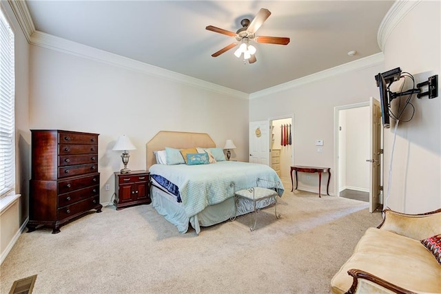 bedroom with ceiling fan, light colored carpet, and crown molding