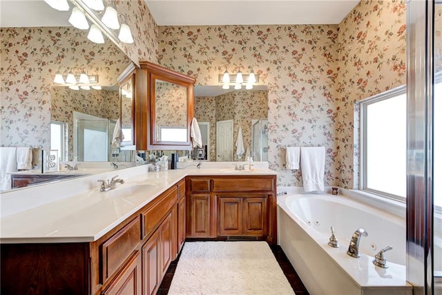 bathroom featuring vanity, independent shower and bath, and a notable chandelier