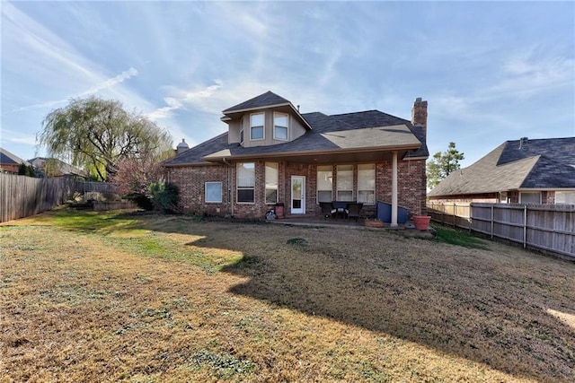 back of property featuring a lawn