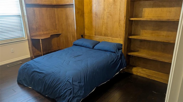 bedroom with dark wood-type flooring