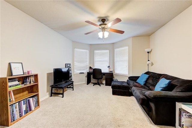 carpeted living room with ceiling fan