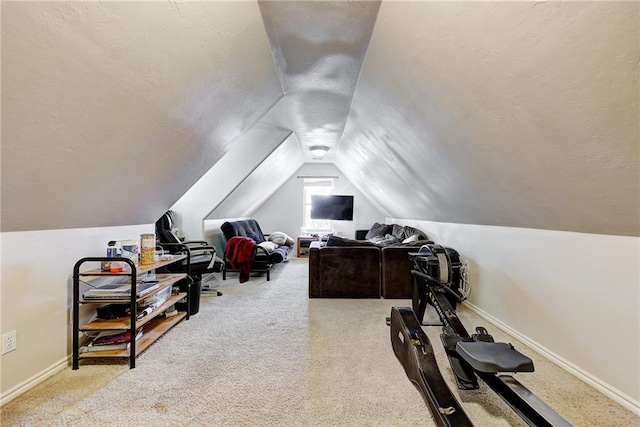 carpeted office featuring lofted ceiling