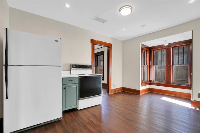 kitchen featuring white appliances and dark wood-type flooring