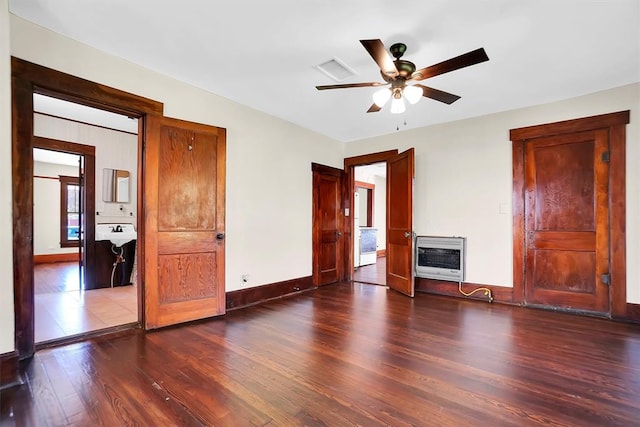 interior space featuring sink, ceiling fan, a fireplace, dark hardwood / wood-style flooring, and heating unit