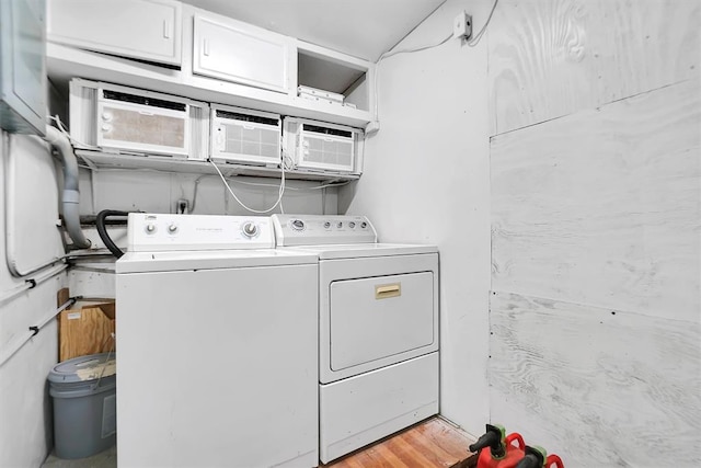 washroom featuring washer and dryer and light hardwood / wood-style floors