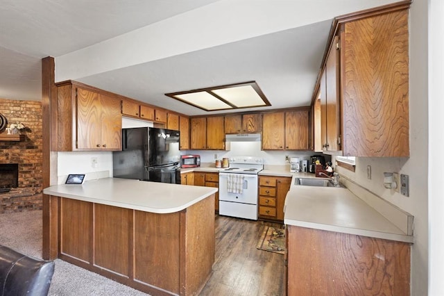 kitchen with sink, dark hardwood / wood-style floors, white range with electric stovetop, kitchen peninsula, and black refrigerator