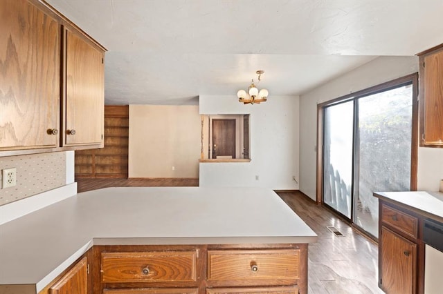 8207 NW 78th St Unit 2, Oklahoma City, OK 73132 - kitchen with light countertops, a chandelier, dishwasher, and a peninsula