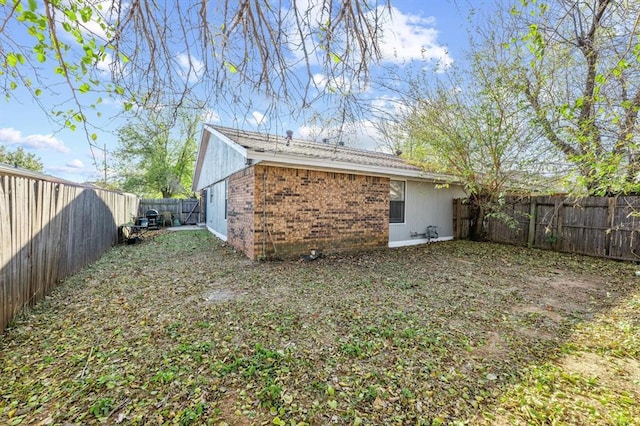 8207 NW 78th St Unit 2, Oklahoma City, OK 73132 - back of house with a fenced backyard and brick siding