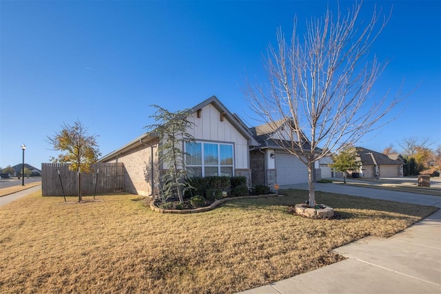 view of front of property featuring a front yard and a garage