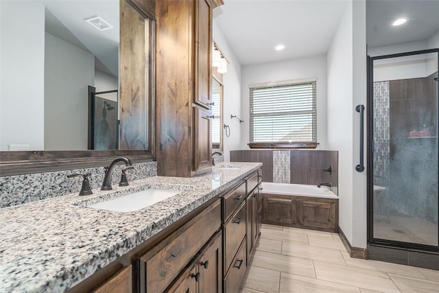 bathroom with separate shower and tub and vanity