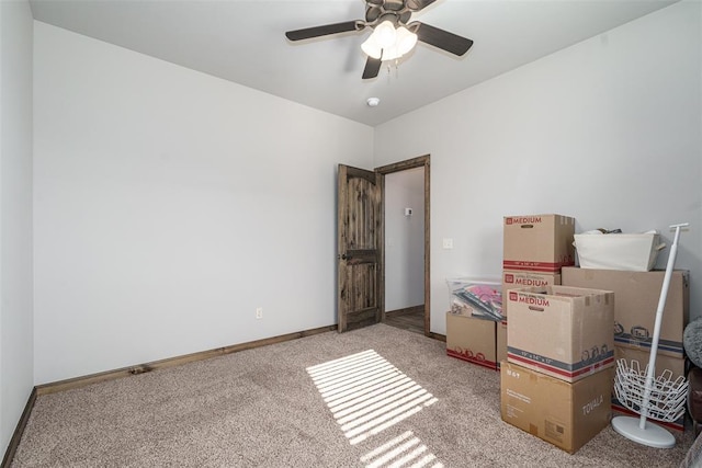 interior space featuring ceiling fan and light carpet