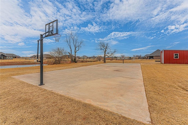 view of basketball court featuring a water view