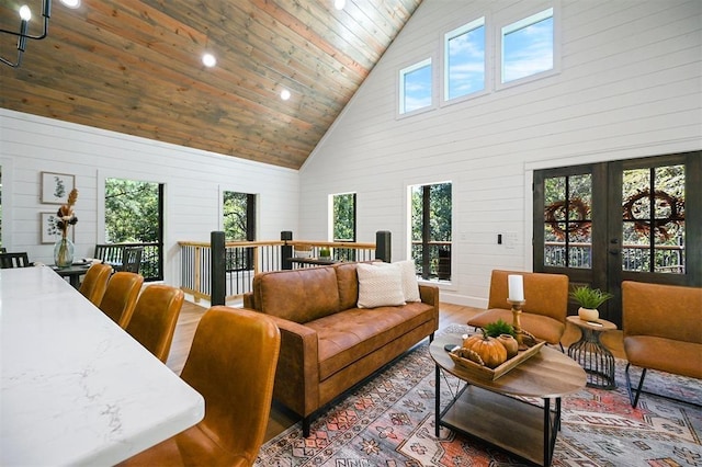 living room with wood walls, high vaulted ceiling, wood ceiling, and hardwood / wood-style flooring