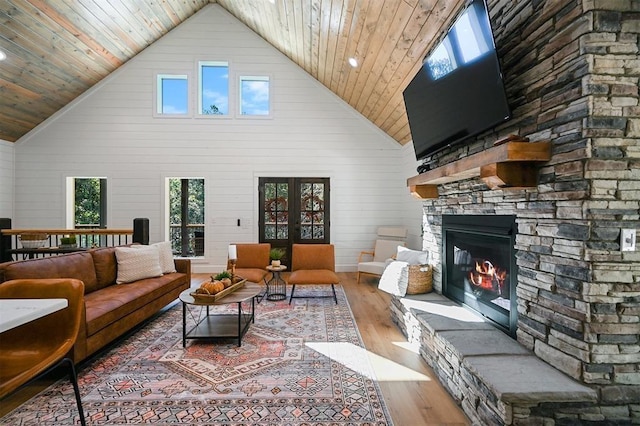 living room with hardwood / wood-style flooring, high vaulted ceiling, and plenty of natural light