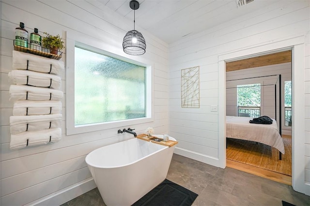 bathroom featuring wood ceiling, a bathtub, and wood walls